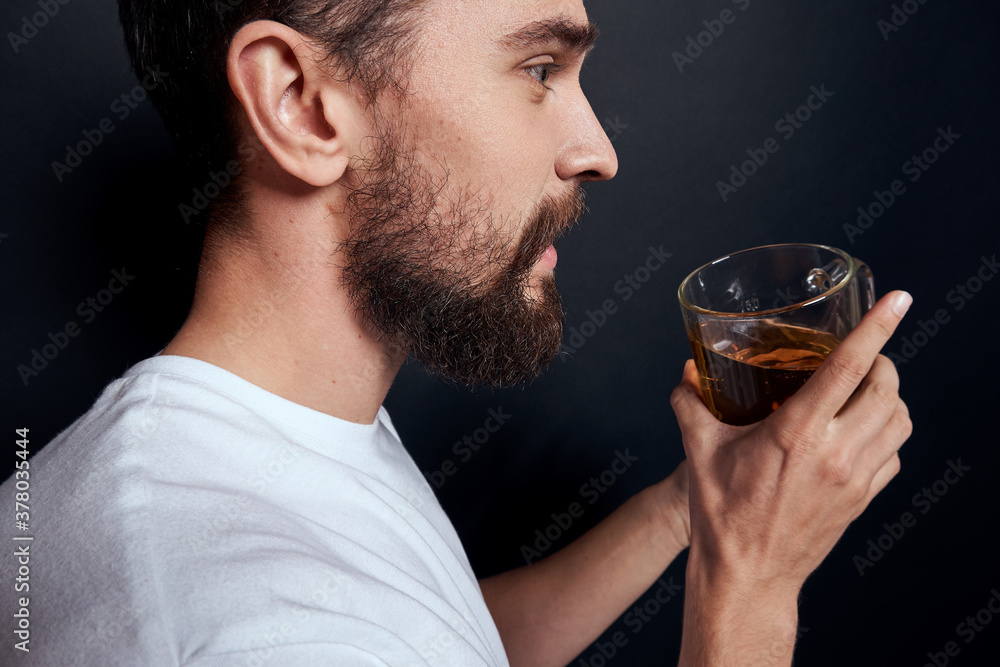 Drunk man with a mug of beer lifestyle alcohol white t-shirt dark background studio cropped view Drunk man with a mug of beer lifestyle alcohol white t-shirt dark background studio cropped view