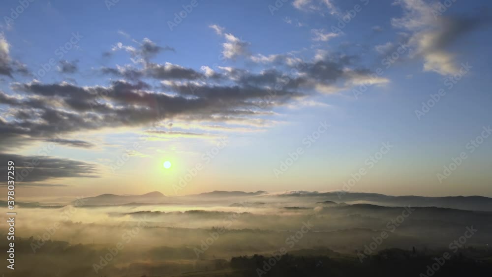 Aerial View of Heavenly Golden Hour Sunlight Above Misty Mystic Valley and Sky. Magical Summer Sunrise and Countryside Landscape, Drone Shot Aerial View of Heavenly Golden Hour Sunlight Above Misty Mystic Valley and Sky. Magical Summer Sunrise and Countryside Landscape, Drone Shot