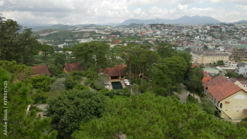 Aerial drone flying backward through the pine trees reveal nice swimming pool with city background 01_Dalat Vietnam Aug2020_4K 60fps Aerial drone flying backward through the pine trees reveal nice swimming pool with city background 01_Dalat Vietnam Aug2020_4K 60fps