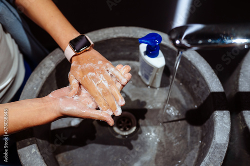 Woman washing hands to protect against the coronavirus