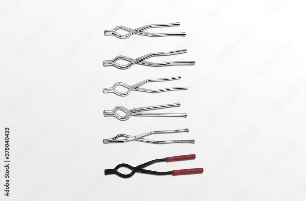 kitchen pincer, A stainless steel kitchen pincer placed upright against a tiled wall. sanachi kitchen pincer, A stainless steel kitchen pincer placed upright against a tiled wall. sanachi