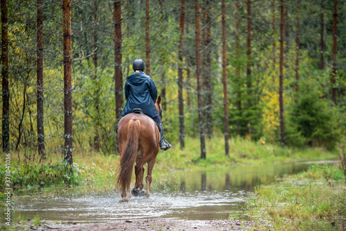 Woman horseback riding in water  © citikka