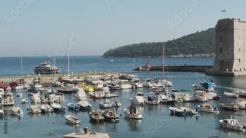 Small harbour in Old Dubrovnik, so called Porporela with moored boats and usual taxi boat traffic. photo