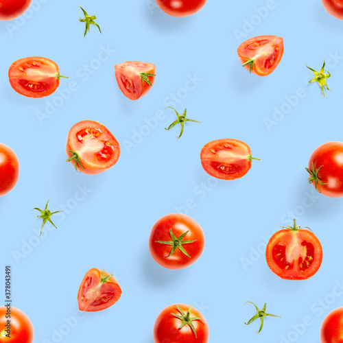 Fototapeta Naklejka Na Ścianę i Meble -  Seamless pattern with red ripe tomatoes. Tomato isolated on blue background. Vegetable abstract seamless pattern. Organic Tomatoes flat lay