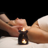 Bodypositive woman with closed eyes in spa salon getting massage. Health, beauty, resort and relaxation concept