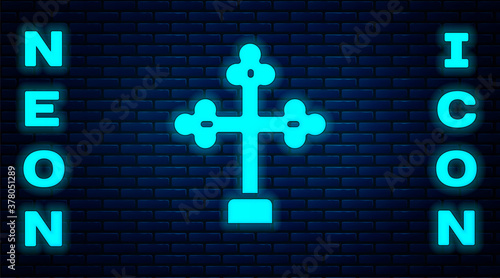 Glowing neon Christian cross icon isolated on brick wall background. Church cross. Vector.