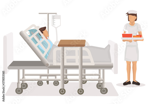 Food delivered to a patient in hospital bed by a nurse.