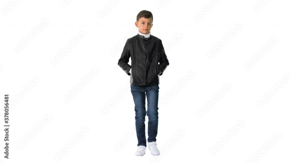 Young boy in a leather jacket walking with his hands in his pockets on white background. Young boy in a leather jacket walking with his hands in his pockets on white background.