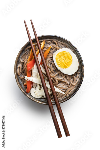 Asian noodle soup with soba noodles, vegetable and egg in bowl.