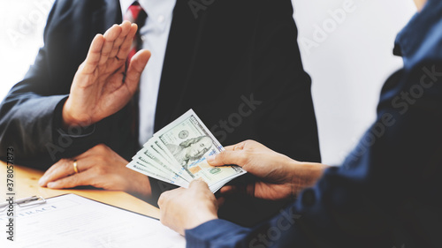 Business people giving dollar bribery for corruption contract.