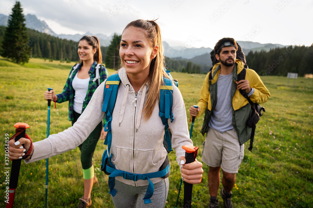 Group of friends hiking together outdoors exploring the wilderness and having fun