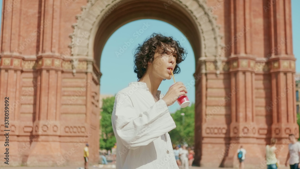 Fototapeta premium Closeup focused man drinking water outdoor. Thirsty man relaxing with liquid.
