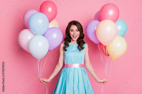 Photo of curly charming lady festive clothes event prom party hold both hands many air balloons celebrate birthday wear blue teal mini dress skirt isolated pastel pink color background