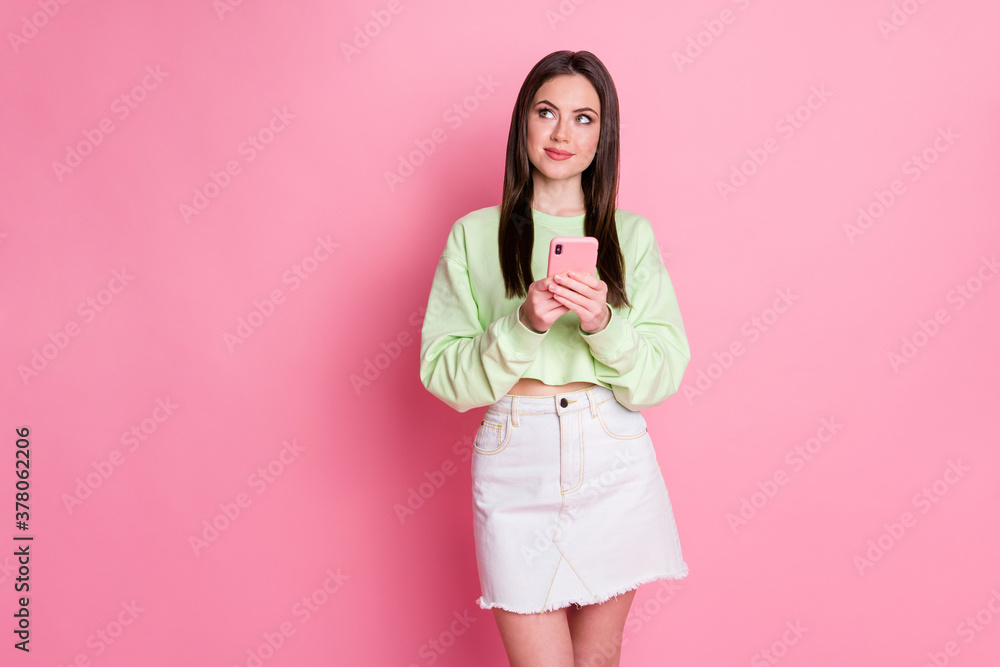 Photo of minded thoughtful girl blogger use smartphone look copyspace decide what texting typing social media account wear green white denim clothes isolated over pastel color background Photo of minded thoughtful girl blogger use smartphone look copyspace decide what texting typing social media account wear green white denim clothes isolated over pastel color background