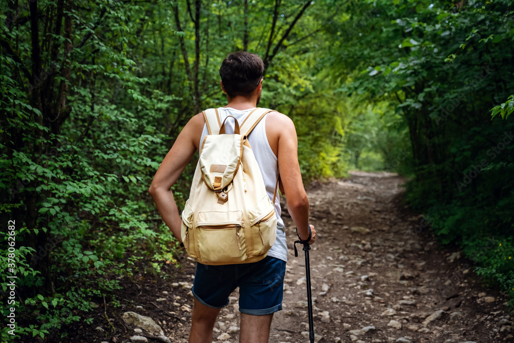 Portrait of a man hiker walking on the trail in the woods. Portrait of a man hiker walking on the trail in the woods.