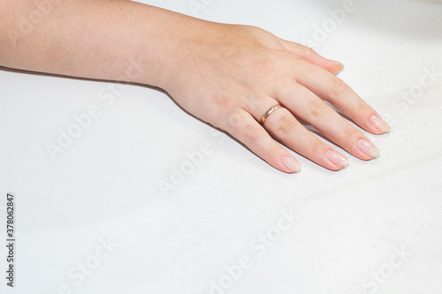 Hand with a fresh manicure on a white background.