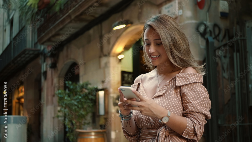 Closeup happy woman looking mobile phone. Pretty lady texting smartphone outdoor Closeup happy woman looking mobile phone. Pretty lady texting smartphone outdoor
