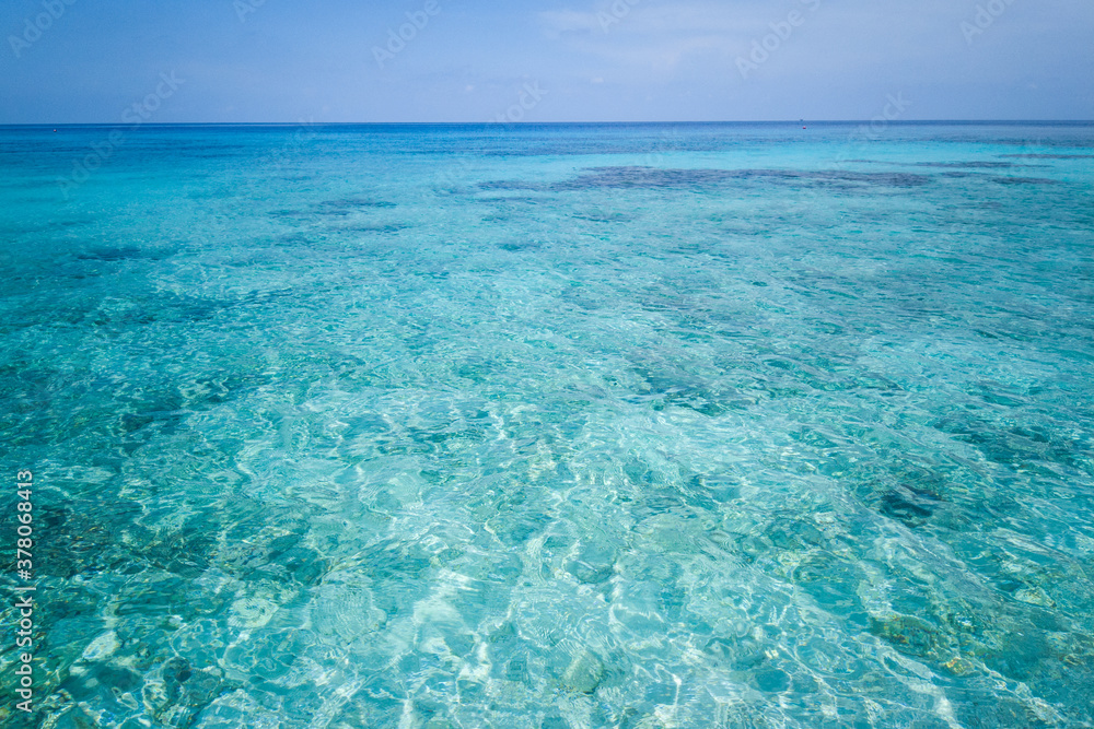 Clear sea water can see the sandy beach in Racha Island, Phuket, Thailand.