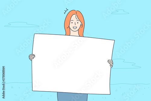 Promotion, business, advertising, protest concept. Young happy smiling businesswoman clerk manager girl cartoon character protestor holding banner in hands looking at camera. Corporate promo ads.