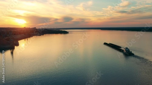 A barge and a coast of a river port at sunset photo