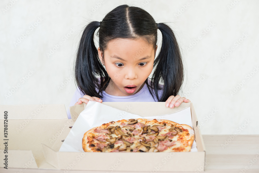 cute little girl holds piece of pizza, hungry student opens mouth wide while sees delicious slice of pizza, wants to eat, positive woman with junk food, people and eating, people and snack concept. cute little girl holds piece of pizza, hungry student opens mouth wide while sees delicious slice of pizza, wants to eat, positive woman with junk food, people and eating, people and snack concept.