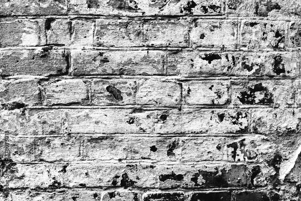 Obraz premium Texture of a brick wall with cracks and scratches which can be used as a background