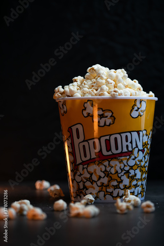A bucket full of popcorn black background photo