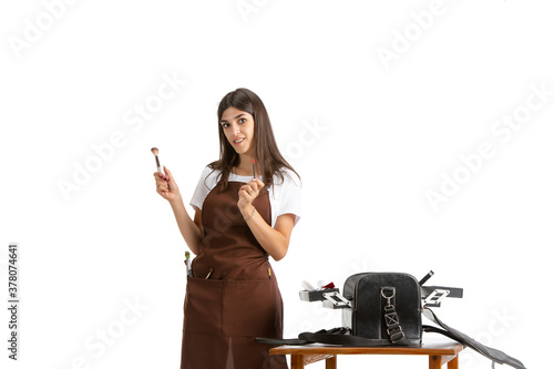 Beauty box. Young beautiful woman, visagiste with cosmetics isolated on white studio background Caucasian woman, art modern worker. Finance, economy, professional occupation, beauty concept. photo