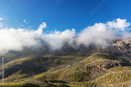 Mountain landscape view in Kyrgyzstan. Green grass in mountain valley view. Mountain panorama.