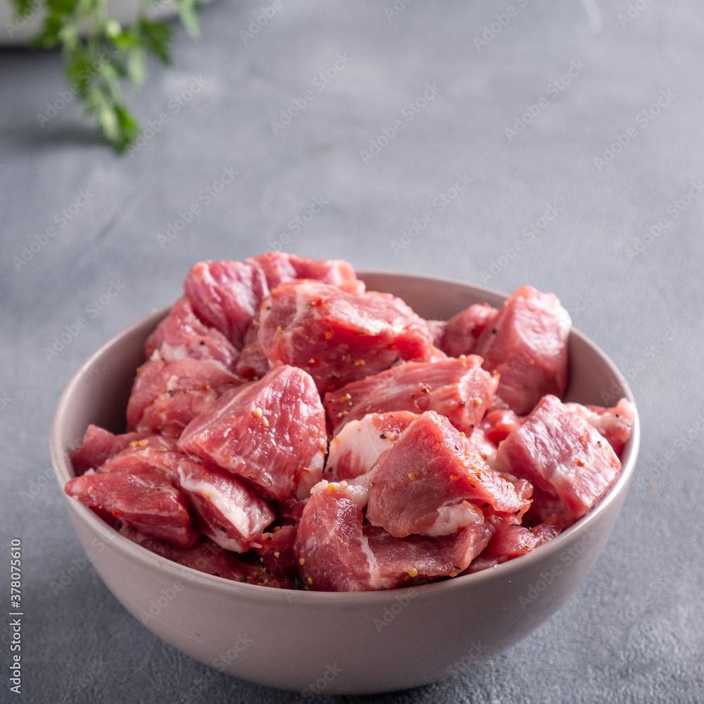 Raw marinated pork meat in a bowl. Raw marinated pork meat in a bowl.