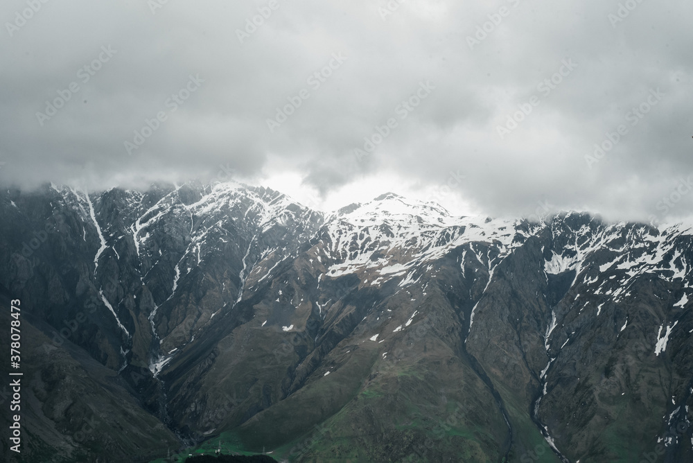mountains of georgia gudaugi mountain peaks ridges in the snow in the green