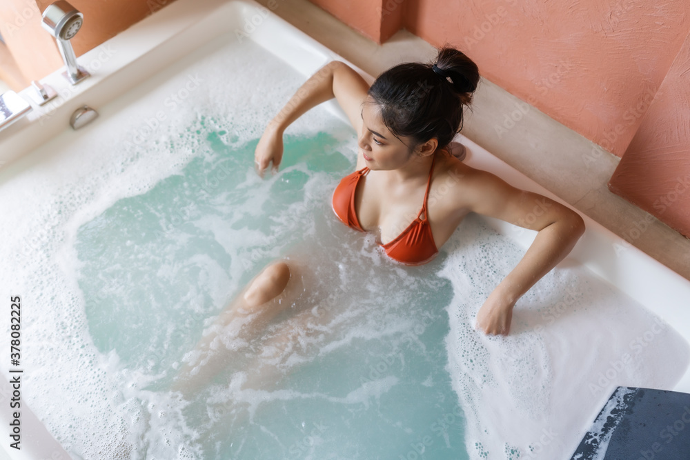 woman in bikini relaxing inside bathtub