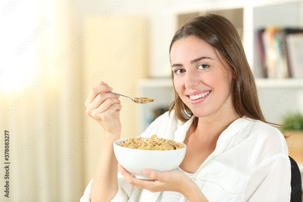 Happy teen eating cereals in the morning at home Happy teen eating cereals in the morning at home