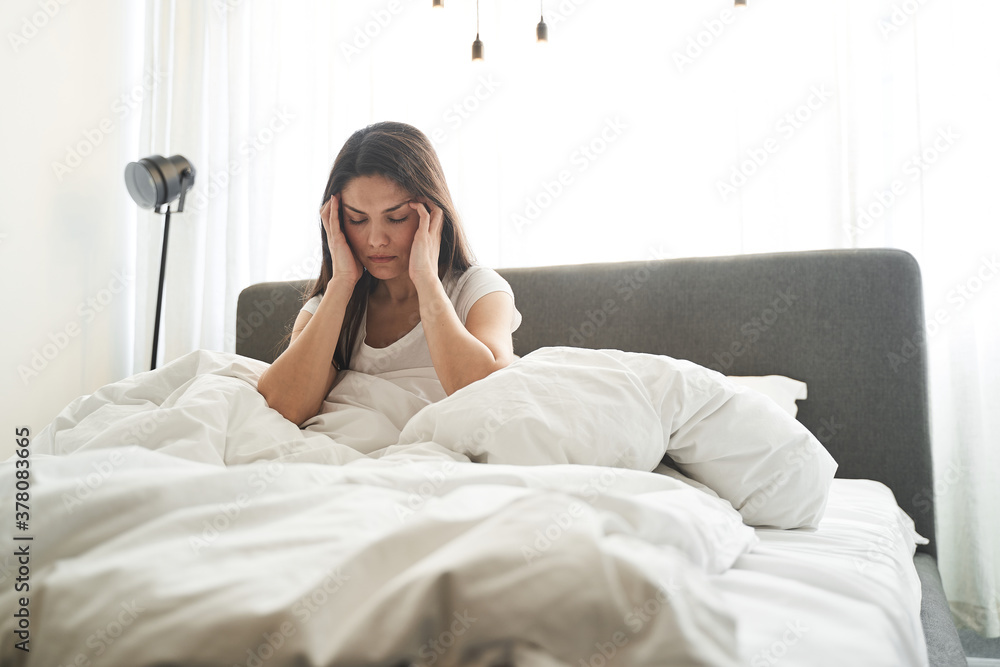 Dark-haired female suffering from a migraine attack Dark-haired female suffering from a migraine attack