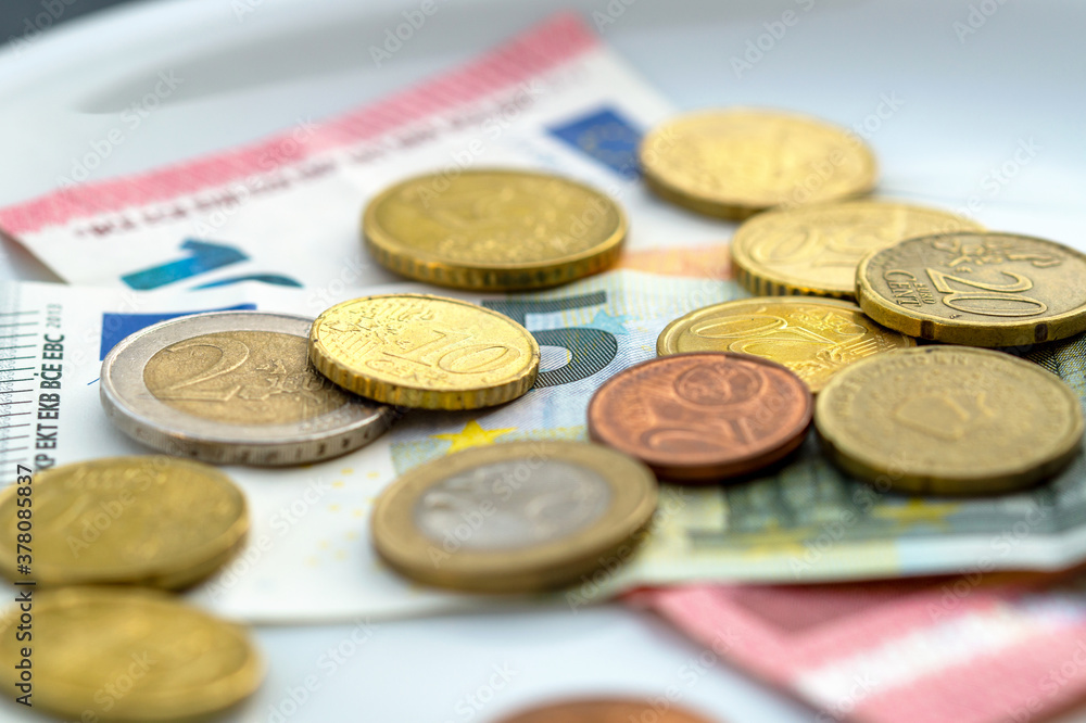 Close-up Of Coins And Currency Note On Plate. High Angle View. euro Money On White Plate. plate with coins and banknote. Toilet - Tip, church collection, rising costs, assets
Close-up Of Coins And Currency Note On Plate. High Angle View. euro Money On White Plate. plate with coins and banknote. Toilet - Tip, church collection, rising costs, assets