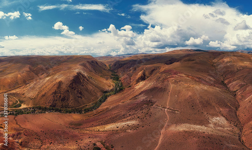 Aerial drone panorama of colorful eroded landform of Altai mountains with yellow  brown and red colors. Nature landscape in popular tourist location called Mars  near the border with Mongolia  Chagan