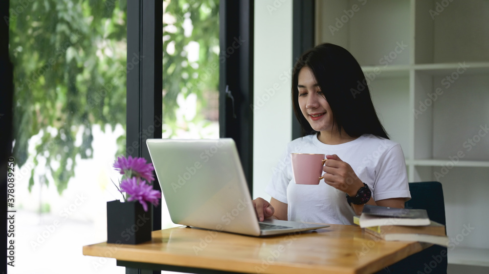 Young entrepreneur work with laptop while have coffee in office. Young entrepreneur work with laptop while have coffee in office.