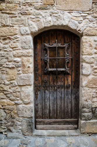 old wooden door in Peratallada town in Catalonia, Spain