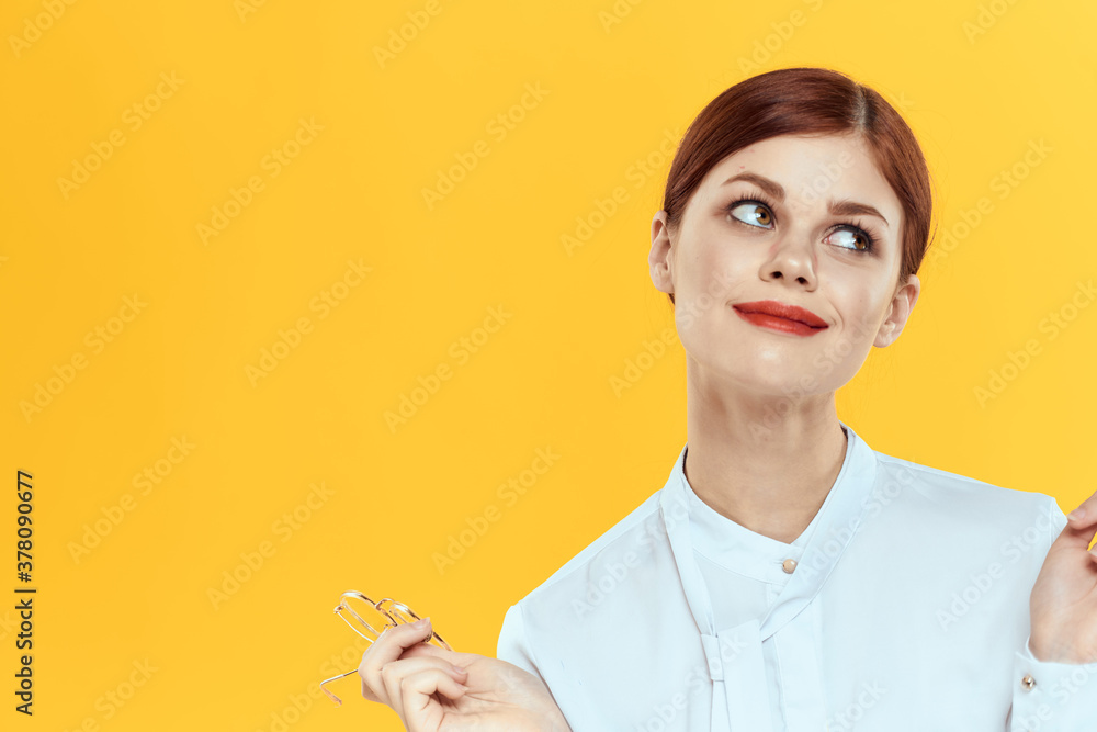 woman in white shirt wearing glasses red lips elegant style yellow isolated background
