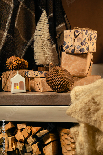 Christmas gifts in brown shades in the evening on a table