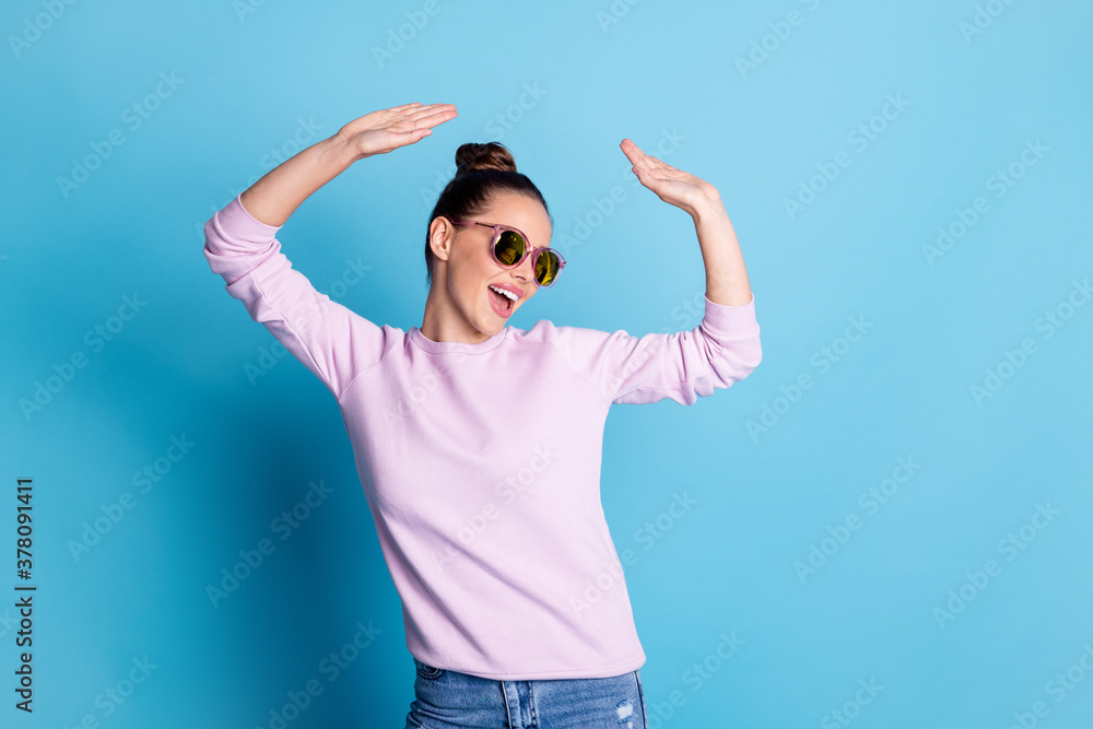 Photo of positive cheerful excited girl enjoy rejoice dance raise hands have party discotheque wear pullover isolated over blue color background Photo of positive cheerful excited girl enjoy rejoice dance raise hands have party discotheque wear pullover isolated over blue color background