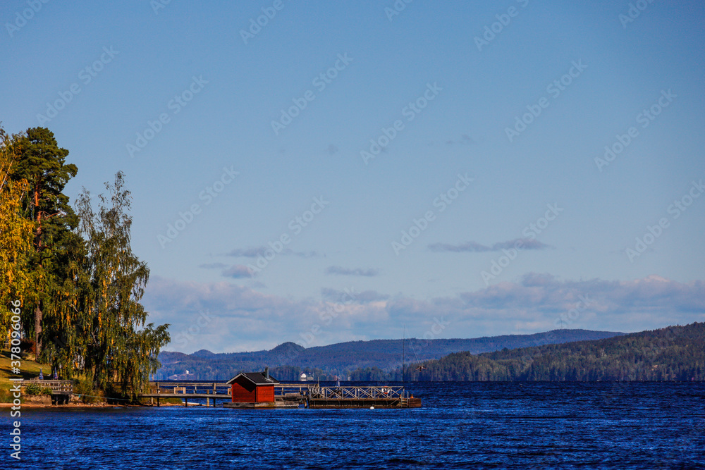 Torsby, Sweden The Mellan-Fryken body of water and small peninsula with red cabin. Torsby, Sweden The Mellan-Fryken body of water and small peninsula with red cabin.