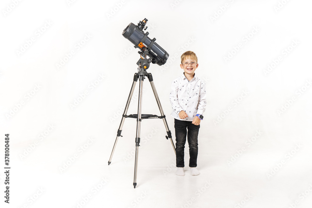 Little boy with a large telescope on a white background.