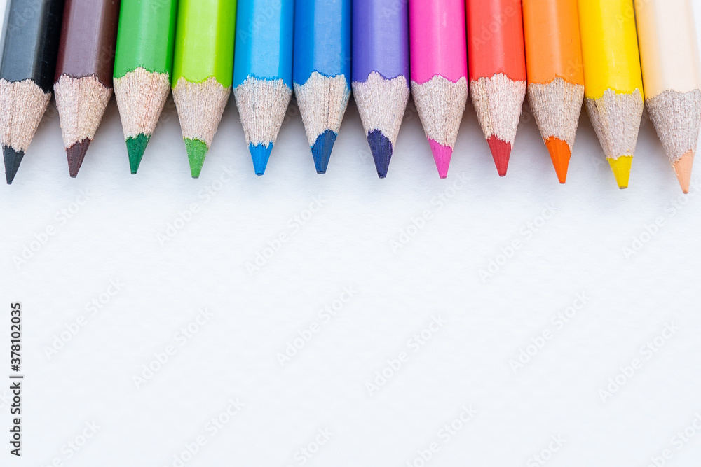 Top view of colourful crayons or colour pencil set in range isolated on white paper background.Education,Business office and Arts Concept.Copy space empty blank for text.Back to school Top view of colourful crayons or colour pencil set in range isolated on white paper background.Education,Business office and Arts Concept.Copy space empty blank for text.Back to school