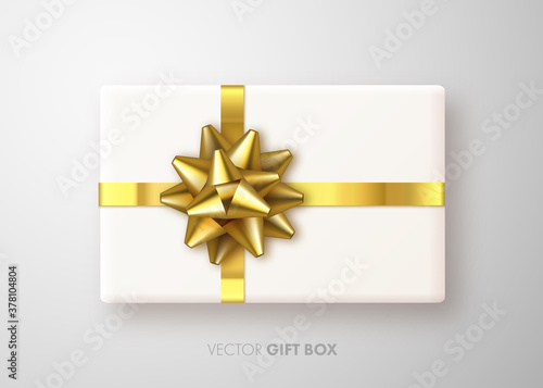 Realistic Gift box with gold bow. Gift presents view top. Happy New Year. Merry Christmas banner. Golden luxury ribbom