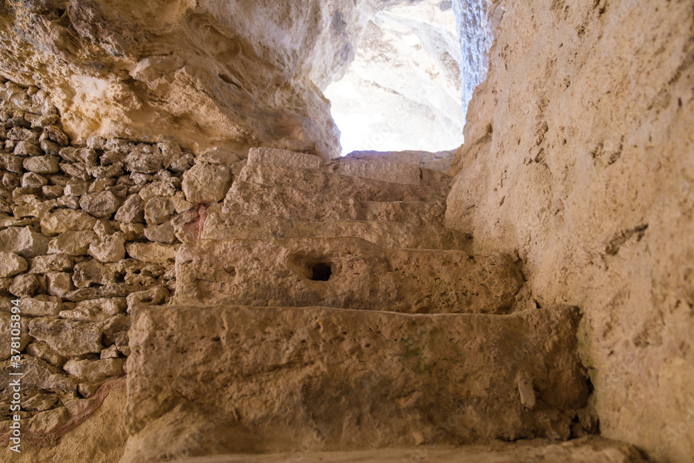 Stairs in ancient rock cave, business success concept