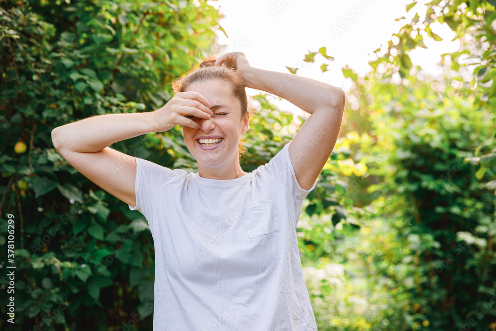 Happy girl smiling outdoor. Beautiful young brunete woman with brown hair resting on park or garden green background. European woman. Positive human emotion facial expression body language. Happy girl smiling outdoor. Beautiful young brunete woman with brown hair resting on park or garden green background. European woman. Positive human emotion facial expression body language.