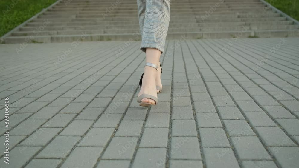 Legs of a woman in high heels in a suit that goes forward Legs of a woman in high heels in a suit that goes forward