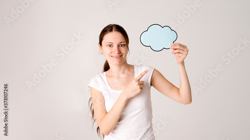 Surprised happy woman in shirt holding blank speech bubble