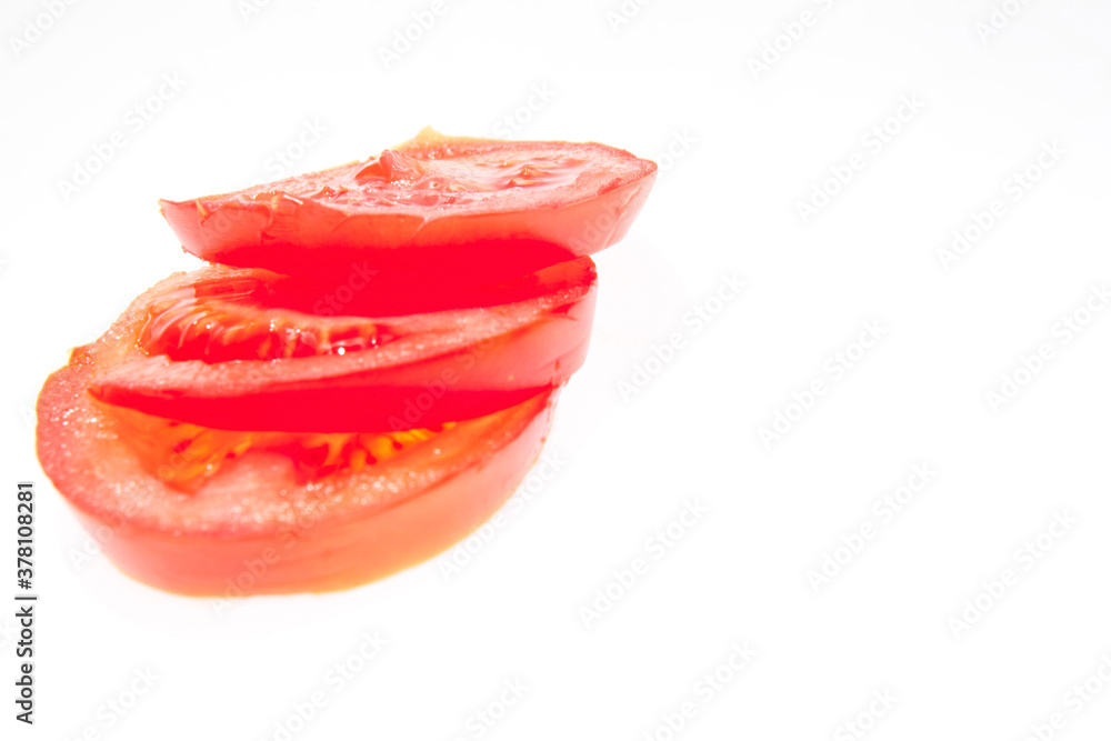 Sliced fresh red tomatoes isolated on the white background Sliced fresh red tomatoes isolated on the white background
